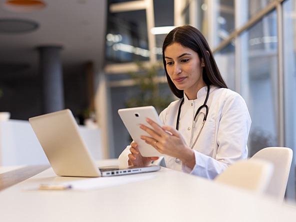 young doctor using laptop and tablet 